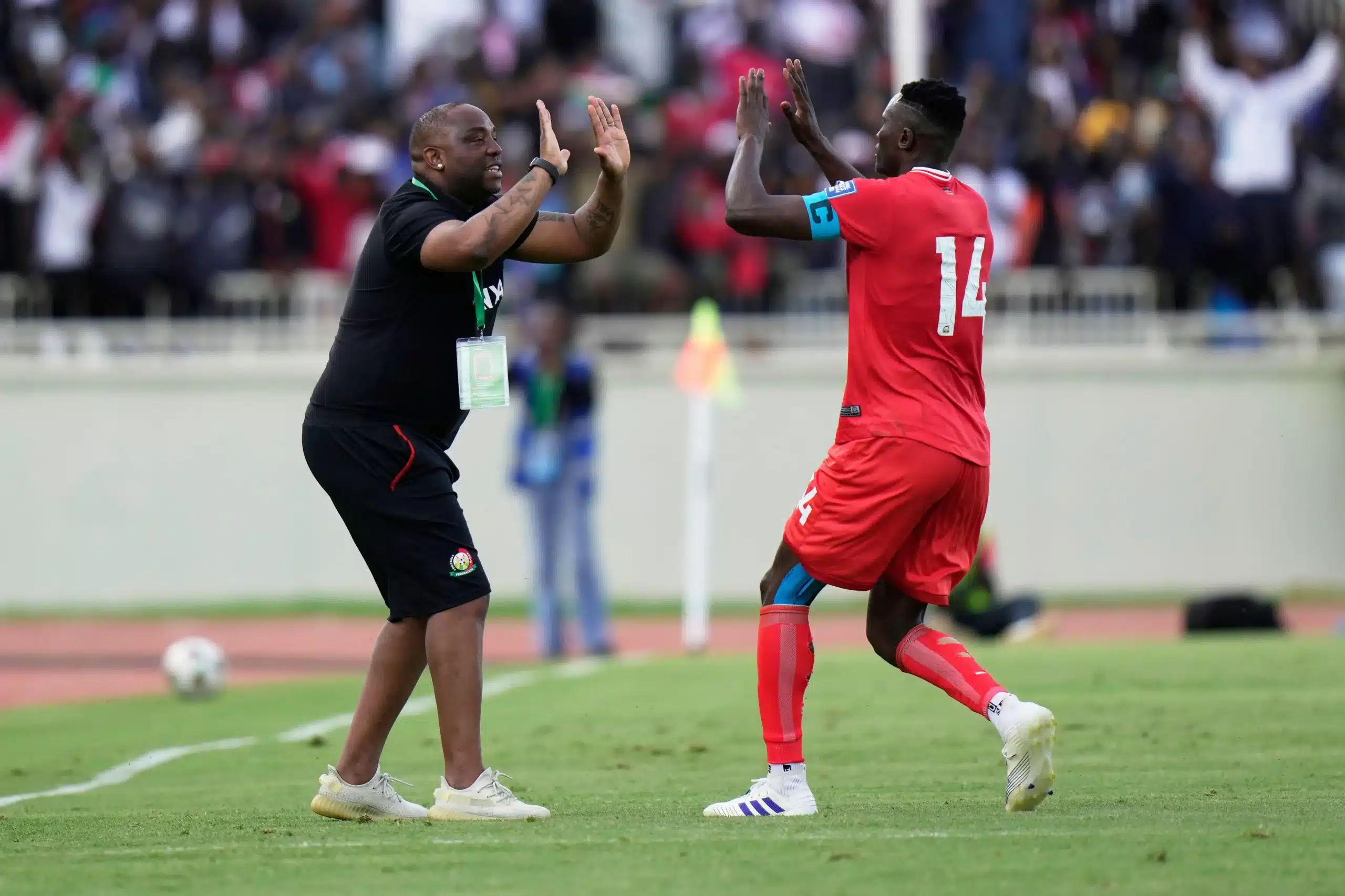 Kenya's head coach Benni McCarthy celebrates with Michael Olunga