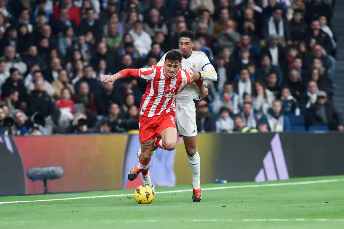 Jude Bellingham (back) of Real Madrid vies with Marc Pubill of UD Almeria during the La Liga football match